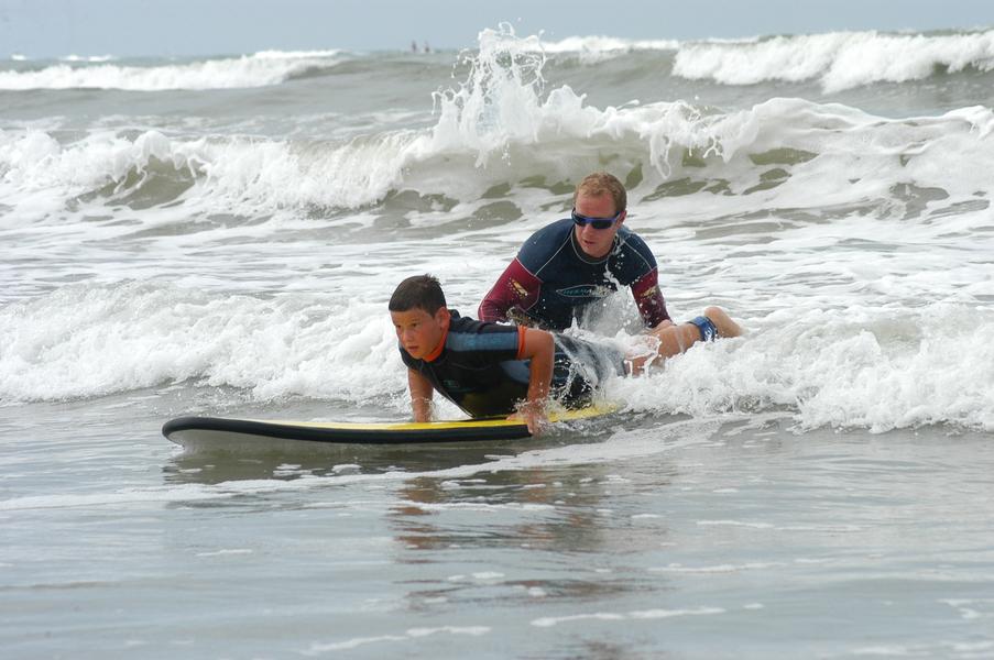 Professeur avec un enfant dans les vagues